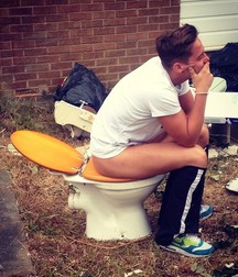 the boy is sitting on the toilet 5d2ae5cc22748.jpg