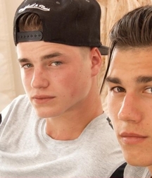 A couple of gay porn models sitting on the sofa 