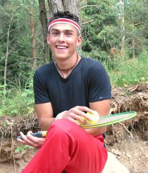 The smiling tennis player Fredi shows off outdoors