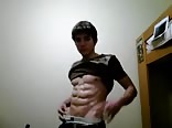 Teen with super abs flexes his muscles