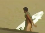 Serfist boy crosses the beach all naked