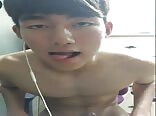 Cute Asian twink porn jerks on Skype with girl he met 